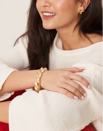 bangle with twist design in brushed gold tone