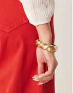 bangle with twist design in brushed gold tone