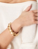 bangle with twist design in brushed gold tone