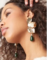 drop earrings in petal design with bead in gold tone